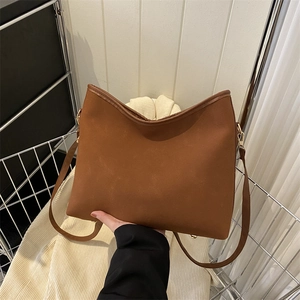 Vintage brown suede tote bag with golden metal buckles and minimalist leather straps
