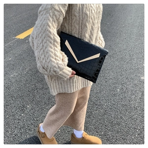 Chic black crocodile pattern envelope clutch with a gold V-shaped metal buckle clasp
