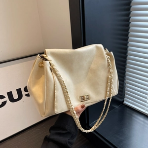 Minimalist beige leather shoulder bag with gold metal lock and chain strap for women
