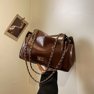 Vintage brown glossy leather chain shoulder bag with gold hardware and flap closure