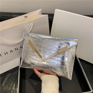 Glossy silver envelope clutch bag with crocodile texture and gold V-shaped metal clasp