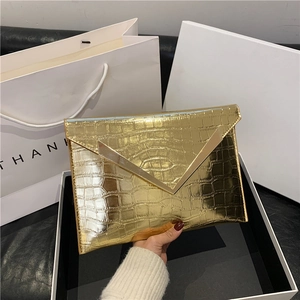 Chic gold envelope clutch with faux crocodile texture and elegant V-shaped metal trim