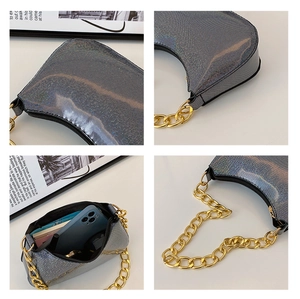 Detailed interior of a holographic underarm bag with gold chain and daily essentials