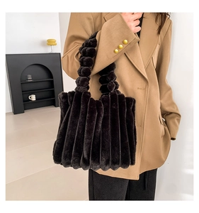 Detail of black faux fur tote bag showing textured plush surface and bubble strap design
