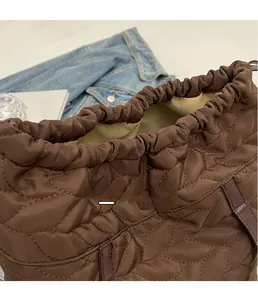 Close-up of brown quilted bag with drawstring closure and soft fabric texture