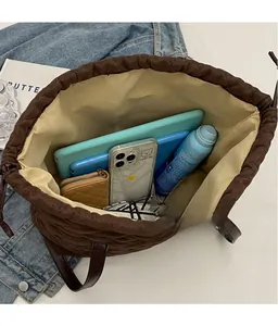 Top-down view of a spacious quilted tote bag showing storage for a tablet and essentials