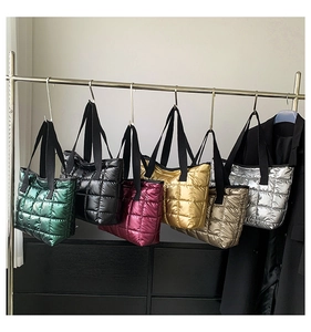 Detailed display of six metallic quilted tote bags showing various colors on a metal rack