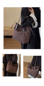 Detail of dark brown quilted nylon shoulder bag featuring leaf-pattern stitching and drawstring