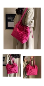 Detail of rose red quilted nylon tote bag with wave texture and adjustable side drawstrings