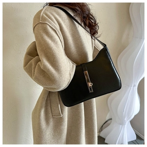 Classic black leather hobo shoulder bag with gold metal buckle shown on model