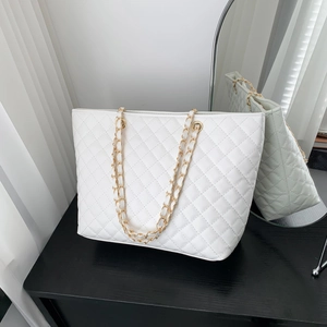 White quilted tote bag with gold chain strap and spacious interior for daily use