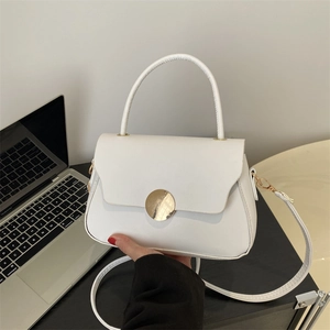 Minimalist white leather handbag with golden round buckle for shoulder and crossbody use
