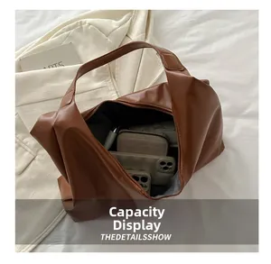 Capacity display of brown PU leather shoulder bag showing ample space for daily items