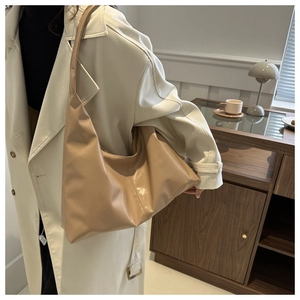 Detailed side view of soft matte PU leather shoulder bag with seamless wide strap design
