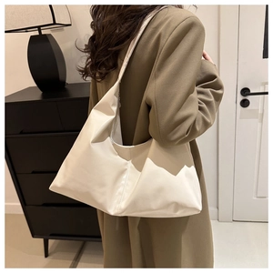 Detail of soft cream white faux leather texture on minimalist large tote shoulder bag