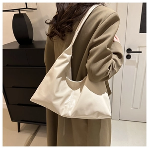 Detailed view of beige soft faux leather shoulder bag with decorative seam and large capacity