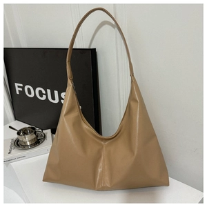 Close-up of khaki hobo bag showing textured faux leather and vertical stitching details