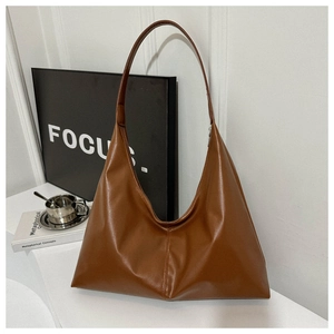 Detailed view of brown faux leather hobo bag with focus on smooth texture and large capacity