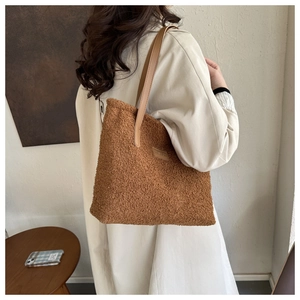 Brown faux fur tote bag styled with a beige trench coat for a trendy winter look