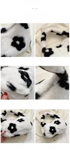 Dettaglio borsa di peluche con motivo floreale bianco e nero e chiusura lampo scorrevole