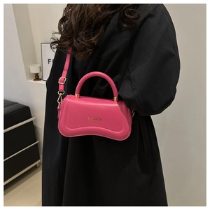 Hot pink PU leather crossbody bag with wavy base design and gold text detail