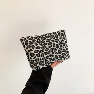 Fashionable leopard print clutch bag in black and white canvas with textured finish