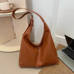 Brown leather large tote bag with adjustable strap and zipper closure for daily commute