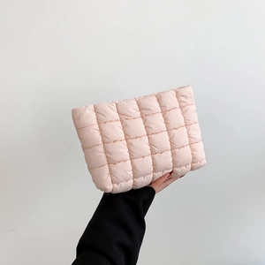 Pink quilted cotton clutch bag with puffy checkerboard embroidery and soft padding