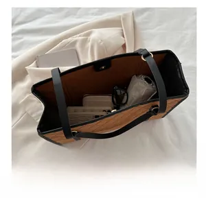 Spacious interior of brown quilted tote bag showing daily essentials like umbrella and wallet