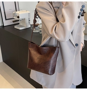 Detail of vintage dark brown leather shoulder bag with Fashion and Sunday embossing