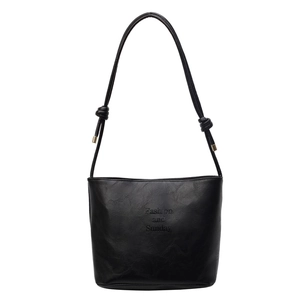 Minimalist black PU leather tote bag with knotted strap and gold hardware accents