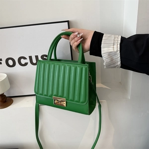 Bright green vertical striped handbag with gold square buckle and adjustable strap