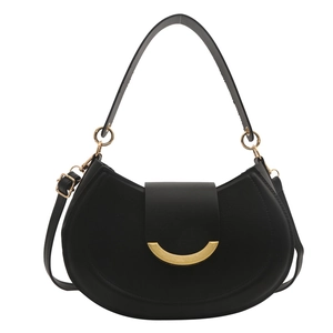 Minimalist black leather saddle bag with gold metal clasp and adjustable shoulder strap