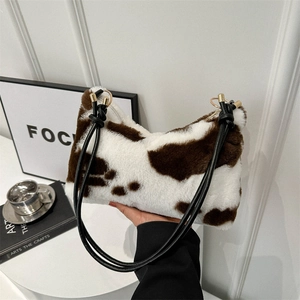 Chic faux fur cow print dumpling bag with black leather straps for spring style