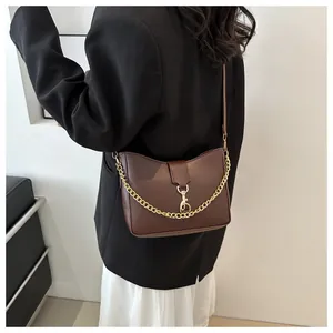 Detail view of dark brown PU leather bag with gold chunky chain and lobster clasp