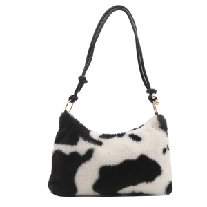 Plush faux fur underarm bag with black and white cow print and knotted strap detail