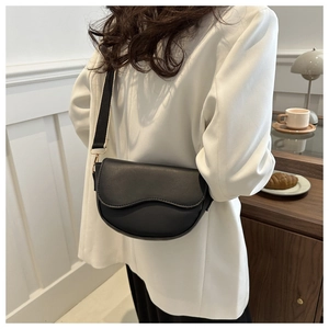 Black PU leather saddle bag detail featuring a stylish black and white fabric wide strap