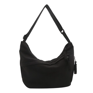 Minimalist black crescent crossbody bag in matte nylon with adjustable wide strap