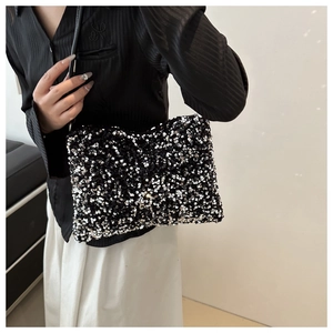 Detail showing shimmering black and silver sequins on a rectangular baguette shoulder bag