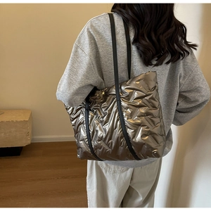 Détail du sac cabas matelassé métallisé bronze avec fines bandoulières en cuir noir