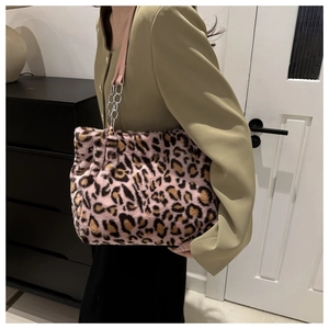 Detail of pink leopard faux fur tote bag with leather strap and silver metal chain accessory