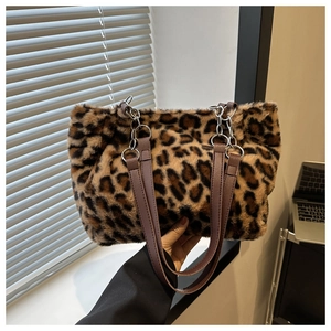 Close-up of leopard print faux fur tote bag with metal chain strap and brown handles