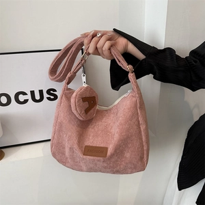Pink corduroy tote bag with adjustable strap and small round coin purse accessory
