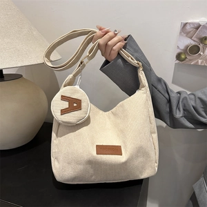 Minimalist beige corduroy tote bag with small round coin purse and adjustable strap