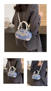 Detail of denim patchwork crossbody bag with silver chain and white leather handles