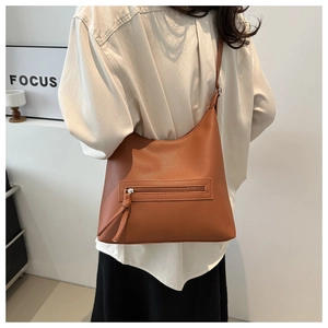 Close-up of caramel hobo bag showing high-quality lychee texture and front zipper