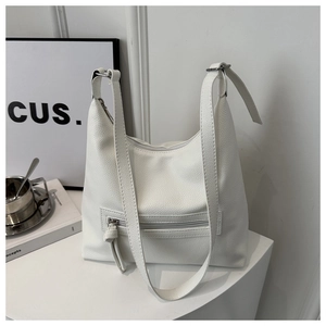 Detail of white lychee pattern tote bag showing side zipper pocket and silver metal buckle