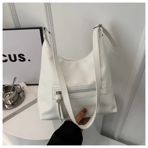 Close-up of white lychee texture leather shoulder bag with functional front zipper detail