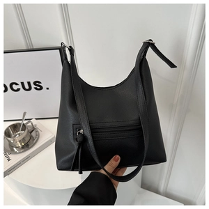 Close-up of black lychee grain leather tote bag with functional front zipper detail