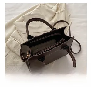 Interior view showing large capacity and zipper compartment of dark brown tote bag